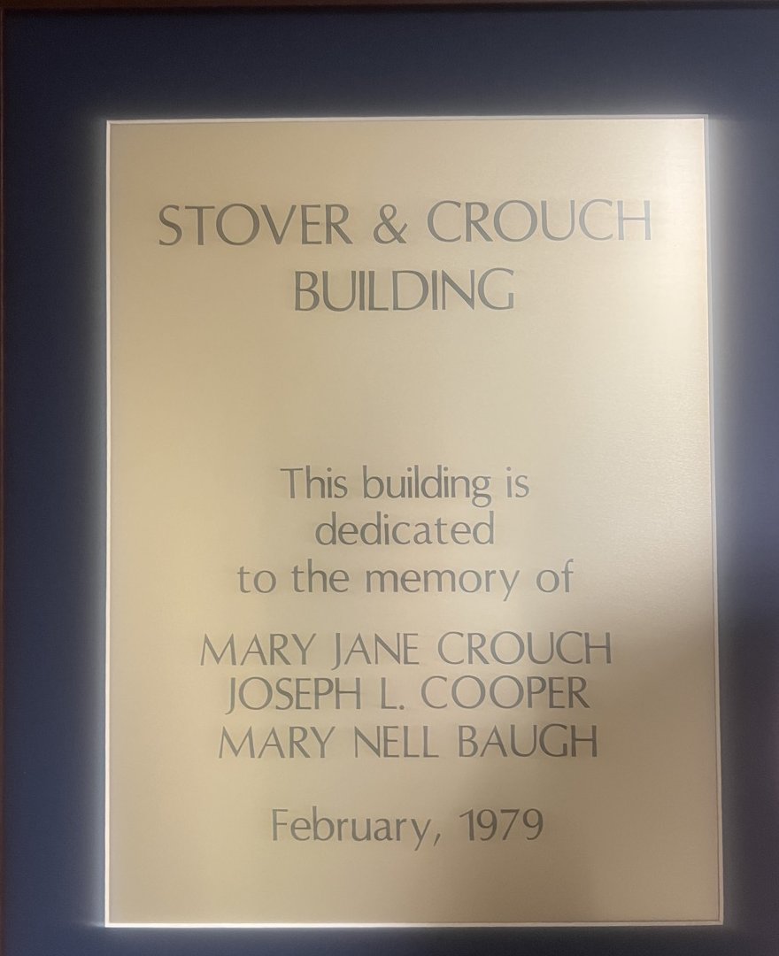 Brass plaque reading Stover and Crouch Building, dedicated February 1979 to the memory of Mary Jane Crouch, Joseph L. Cooper, and Mary Nell Baugh