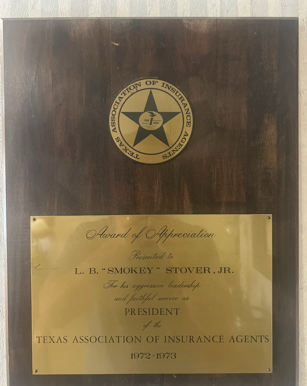 Wood and brass plaque honoring L. B. Smokey Stover Jr. as president of the Texas Association of Insurance Agents 1972 to 1973